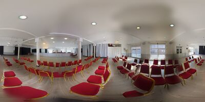 The same hall with the roller shutters open, showing how much daylight the room takes.